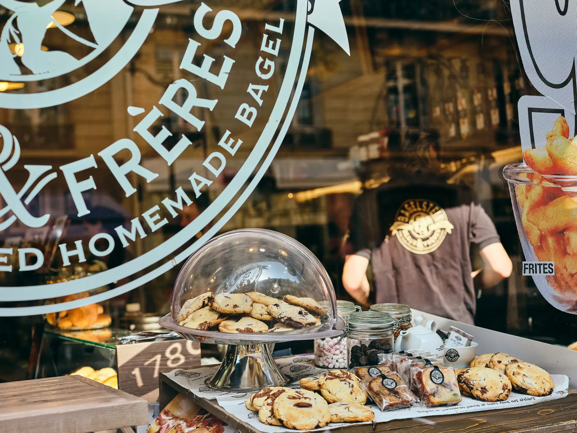 Cookies et pâtisseries en vitrine derrière le logo Bagelstein